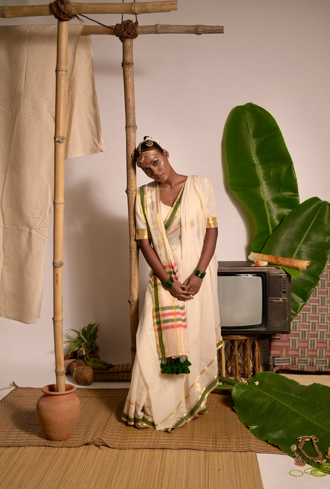 Kathakali Off white handwoven mul cotton saree with green and zari border