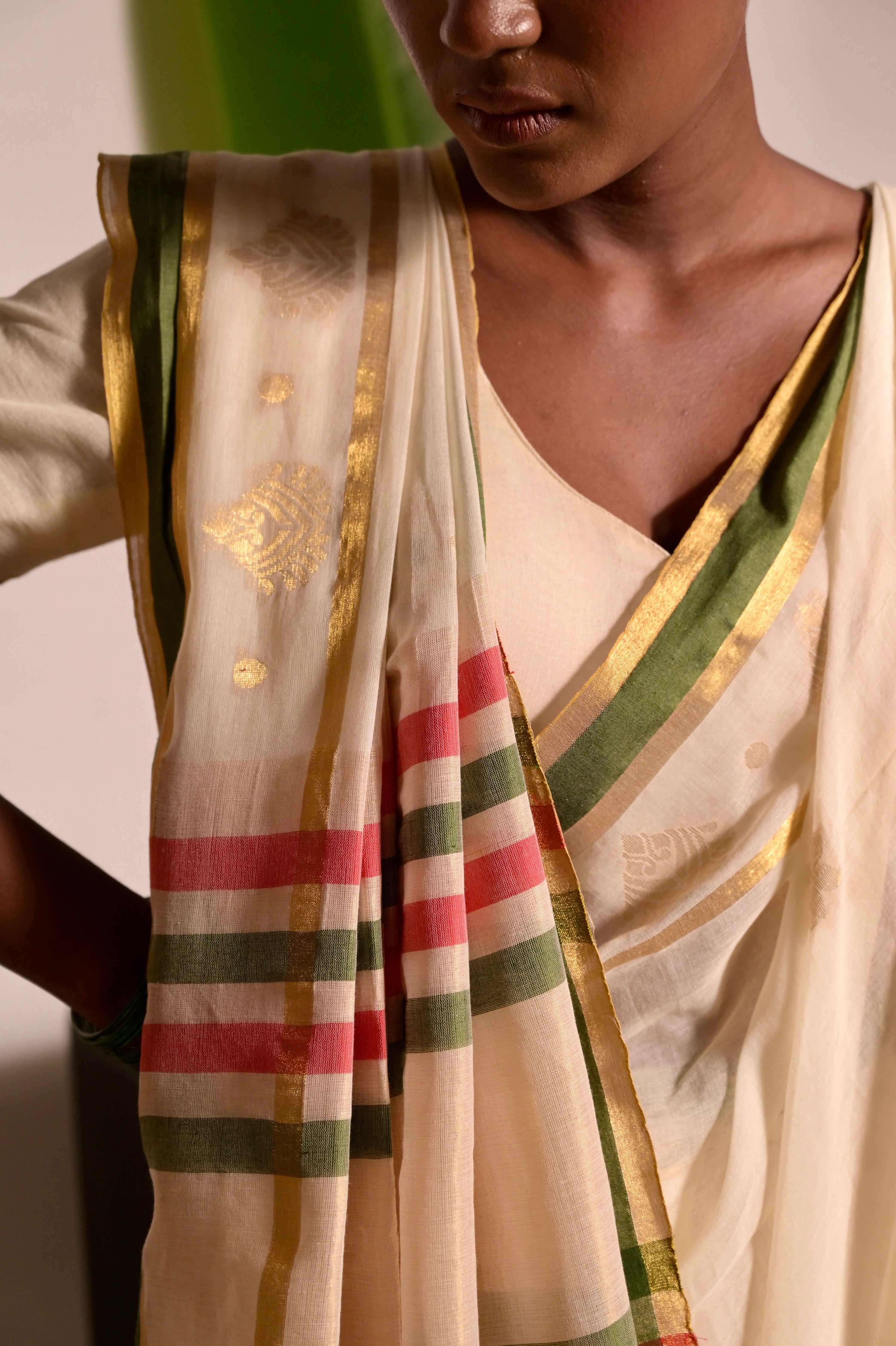 Kathakali Off white handwoven mul cotton saree with green and zari border