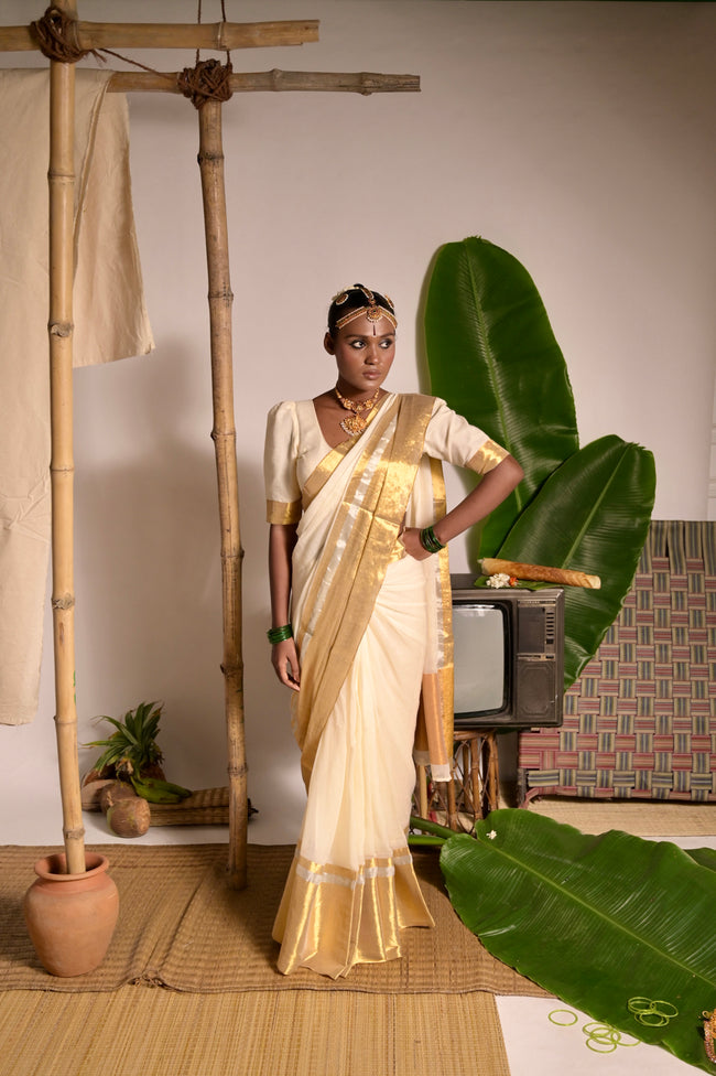 Swarnamaya Off white mul cotton handwoven saree with golden border
