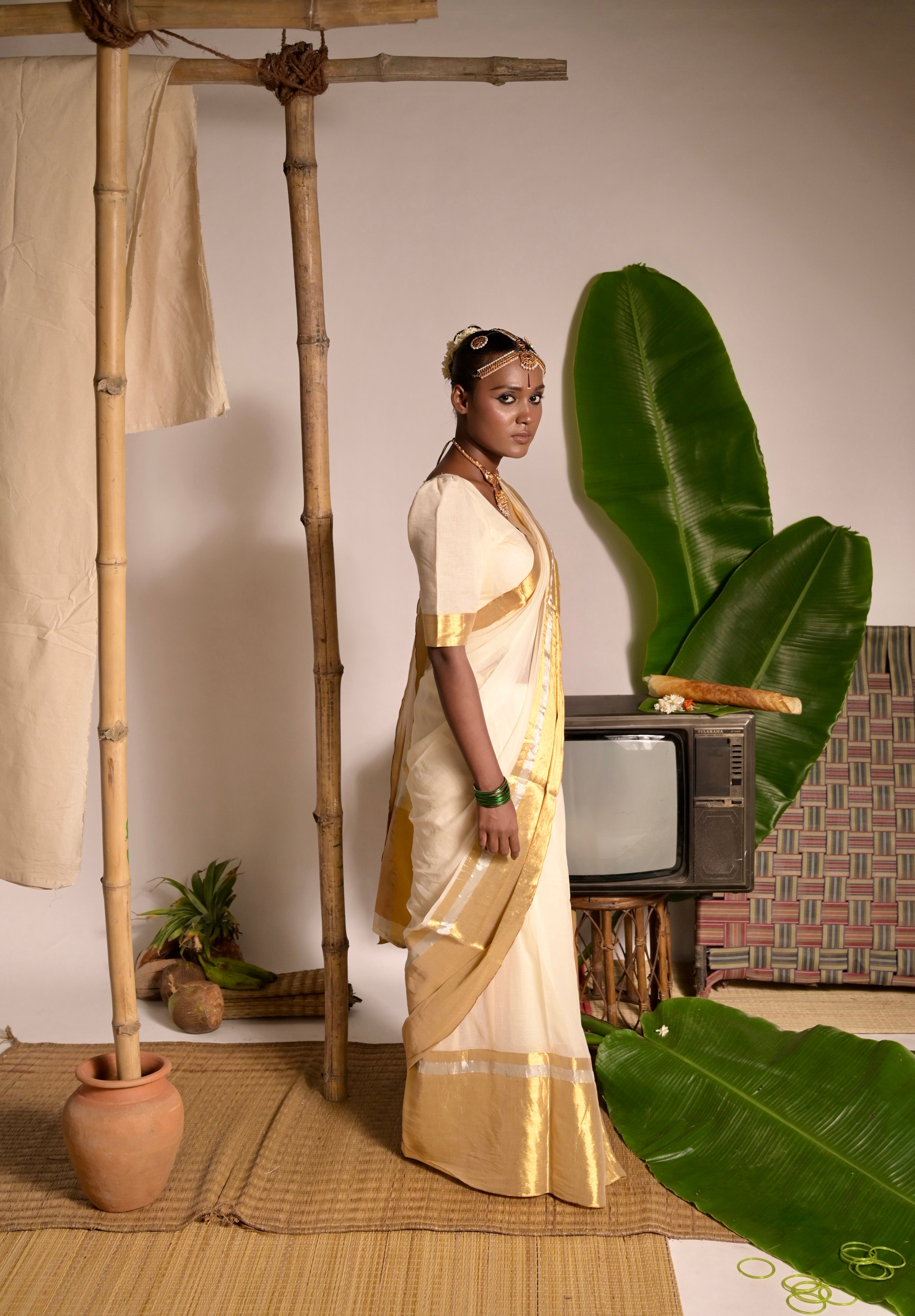Swarnamaya Off white mul cotton handwoven saree with golden border