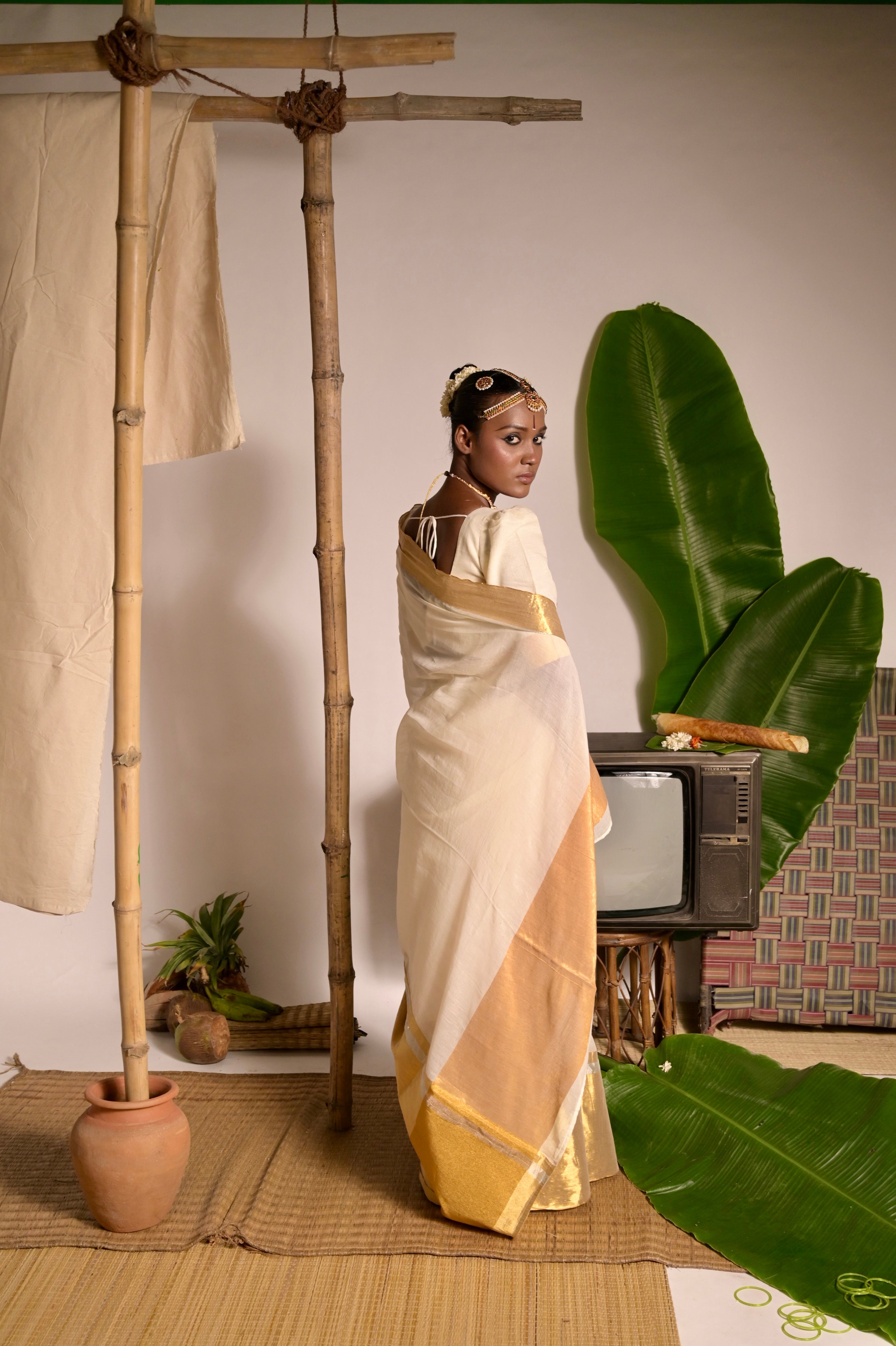 Swarnamaya Off white mul cotton handwoven saree with golden border