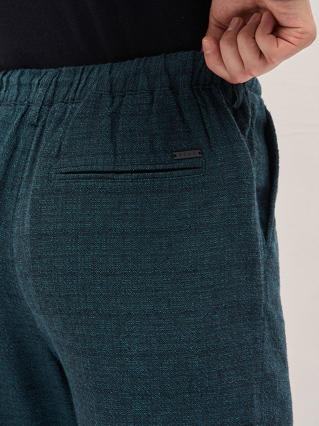 Men Teal Self Design Tapered Fit Elasticated Waist Casual Trouser